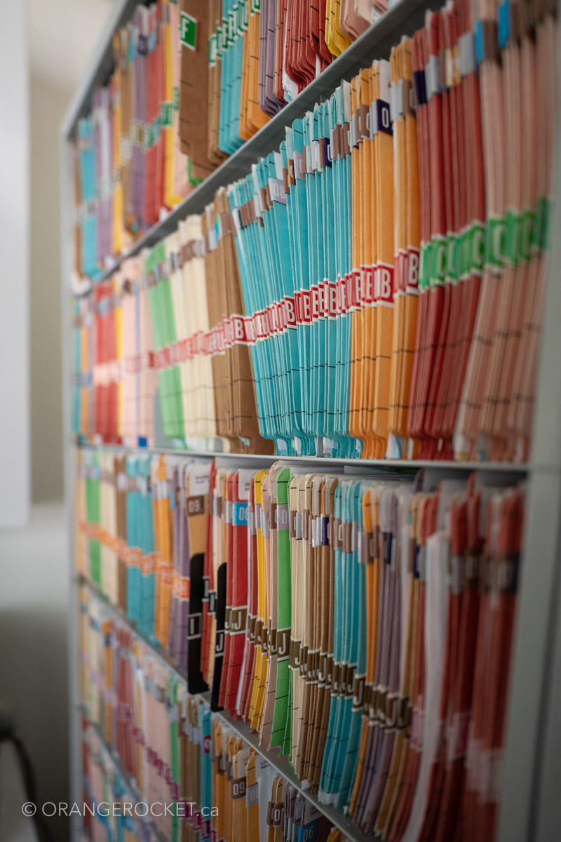 Organized patient file folders on clinic shelves
