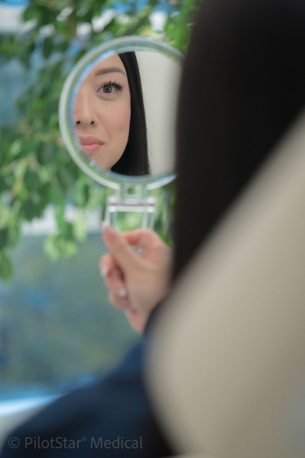 Patient looking into a handheld mirror