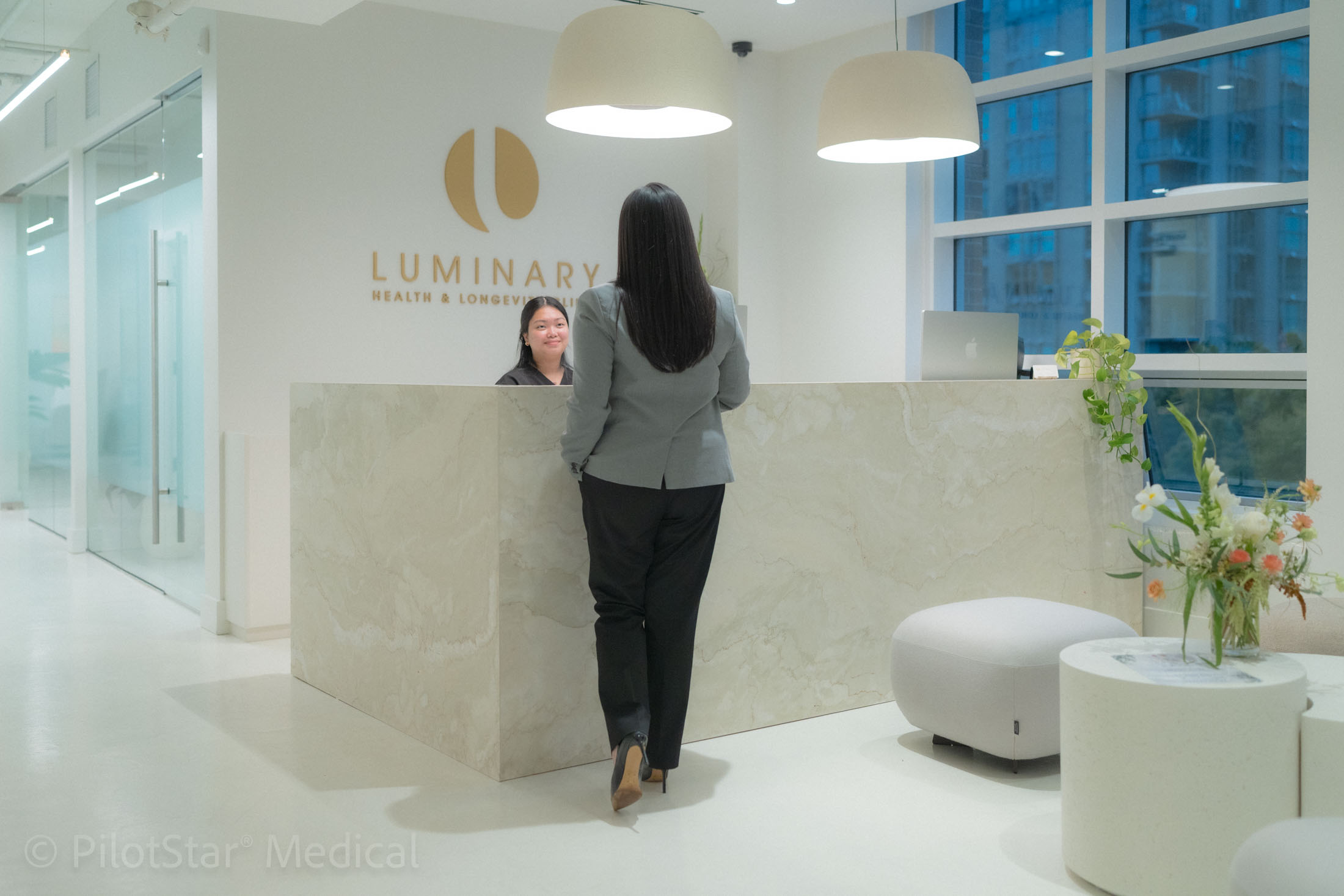 Visitor at the Luminary Health reception desk