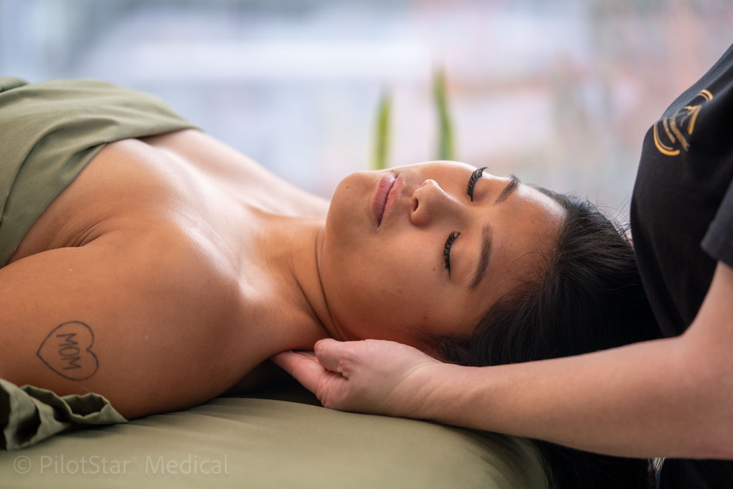 Patient receiving hands-on neck treatment