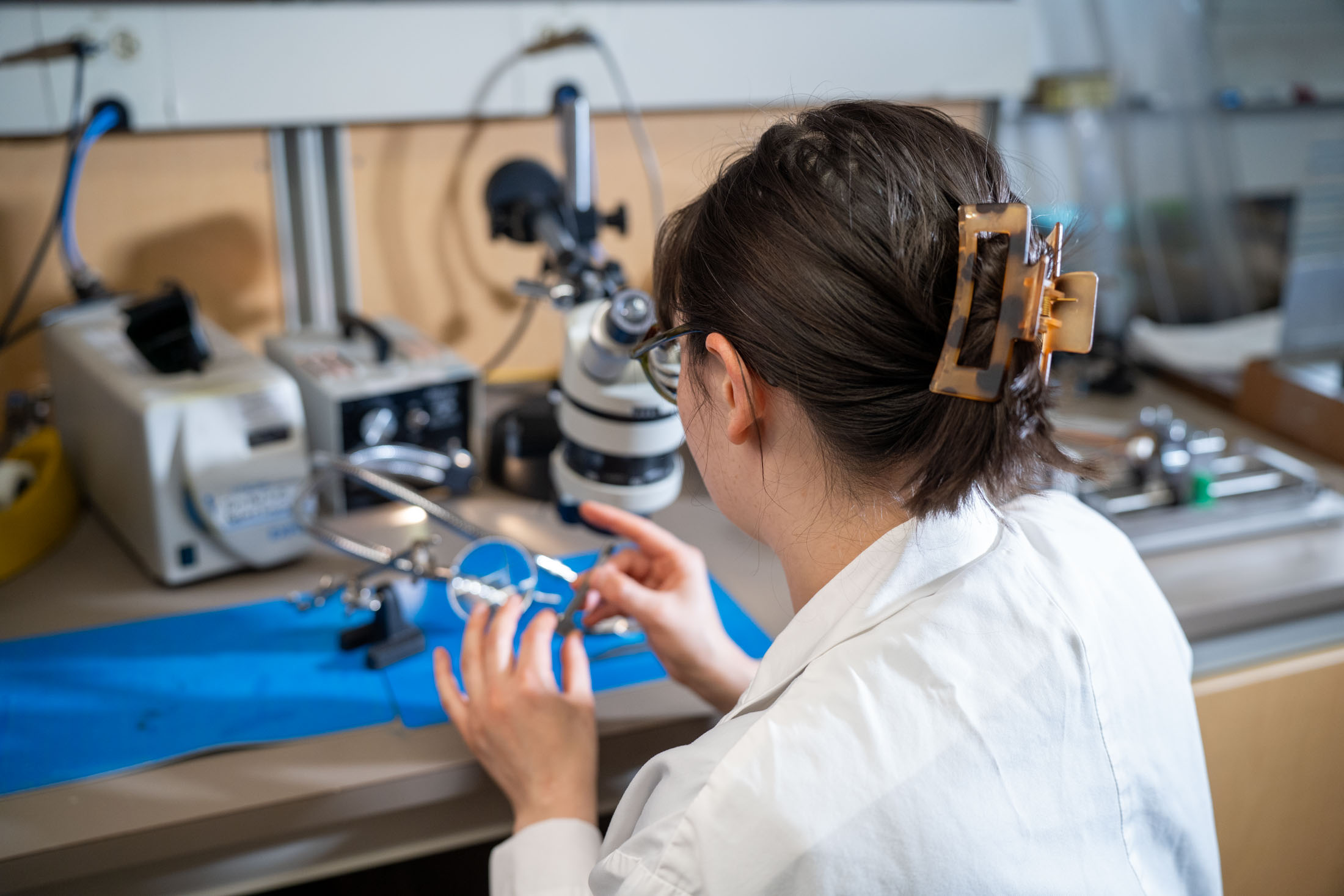 Researcher standing in a laboratory surrounded by scientific equipment